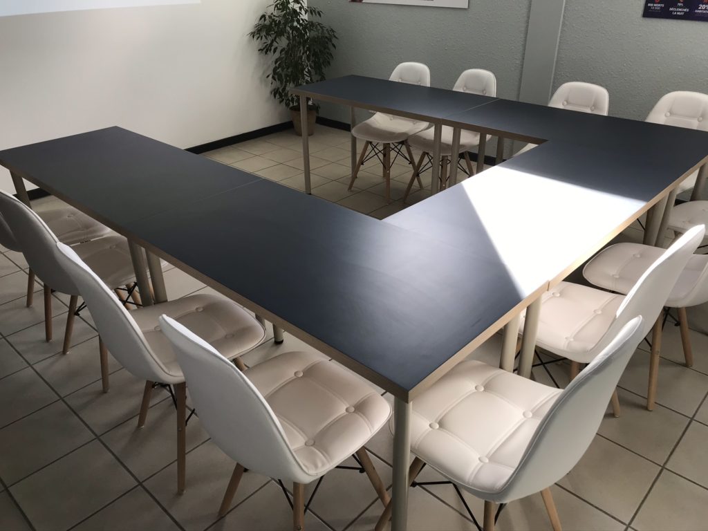 chaises blanches tables noires en U 