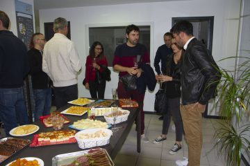 table avec nourriture (buffet) avec des gens debout autour